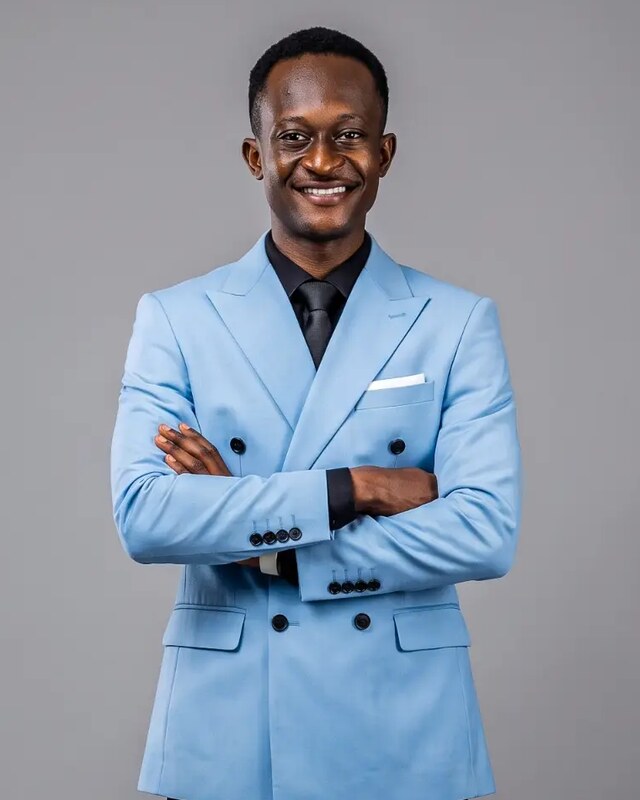 Gabriel Addison, graphic designer, wearing a light blue suit